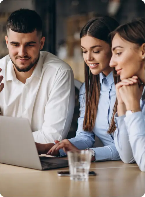 boy and two girls working on same laptop