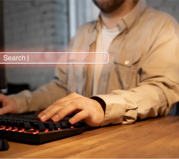 person on computer using search bar